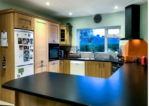 u-shaped kitchen with black granite worktop