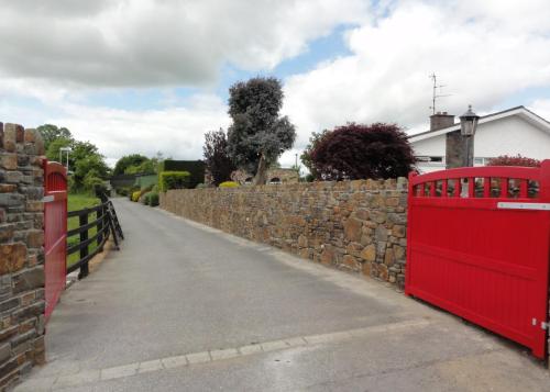 red gate and stone wall 