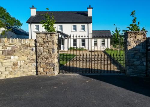 Large house with new gate and stone pillars