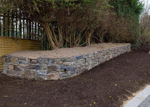 Garden bed with trees and stonework